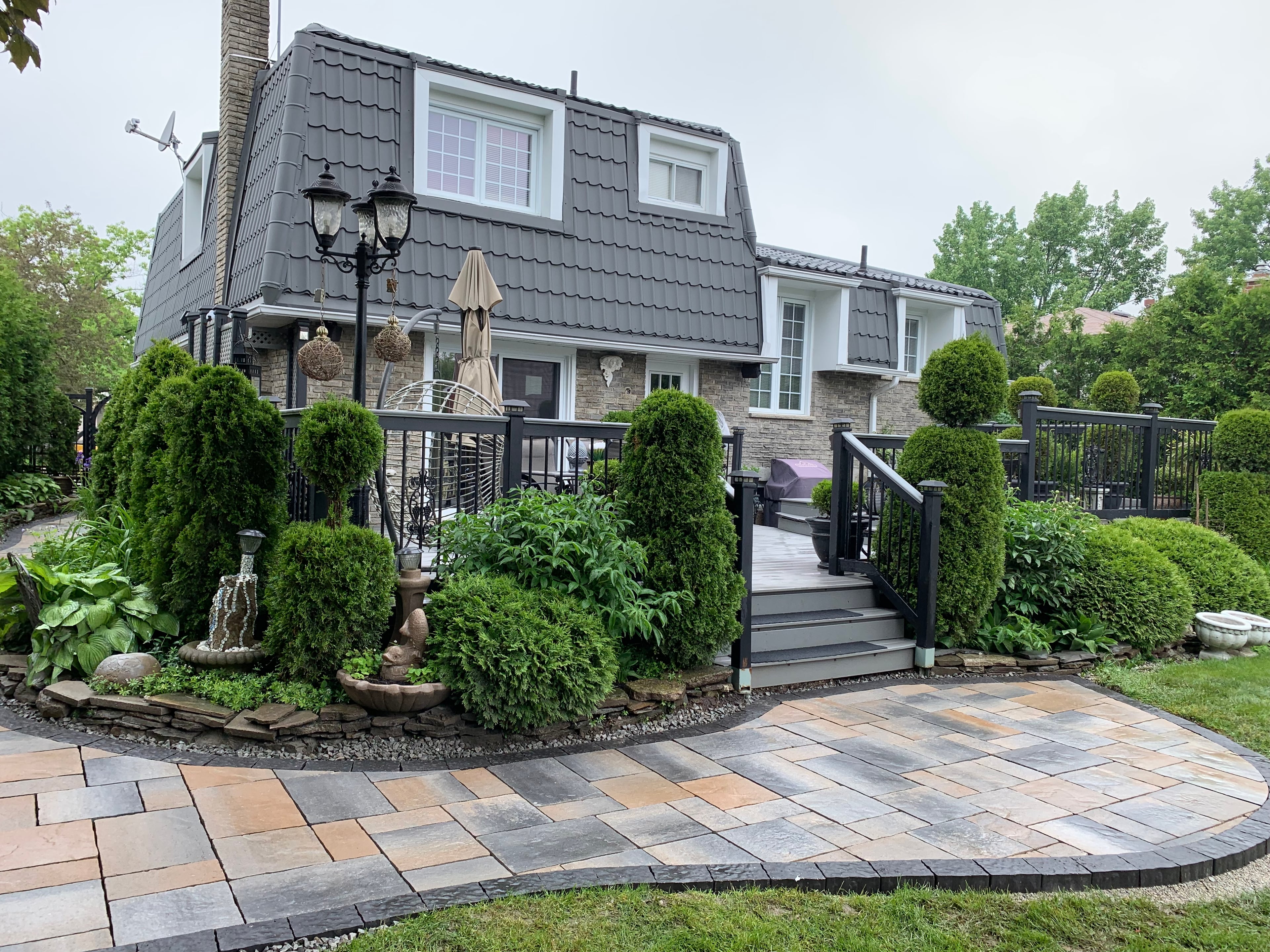 Front entrance hardscape with interlocking steps, patio landing, garden bed and new sod in Acton by BCI Landscaping
