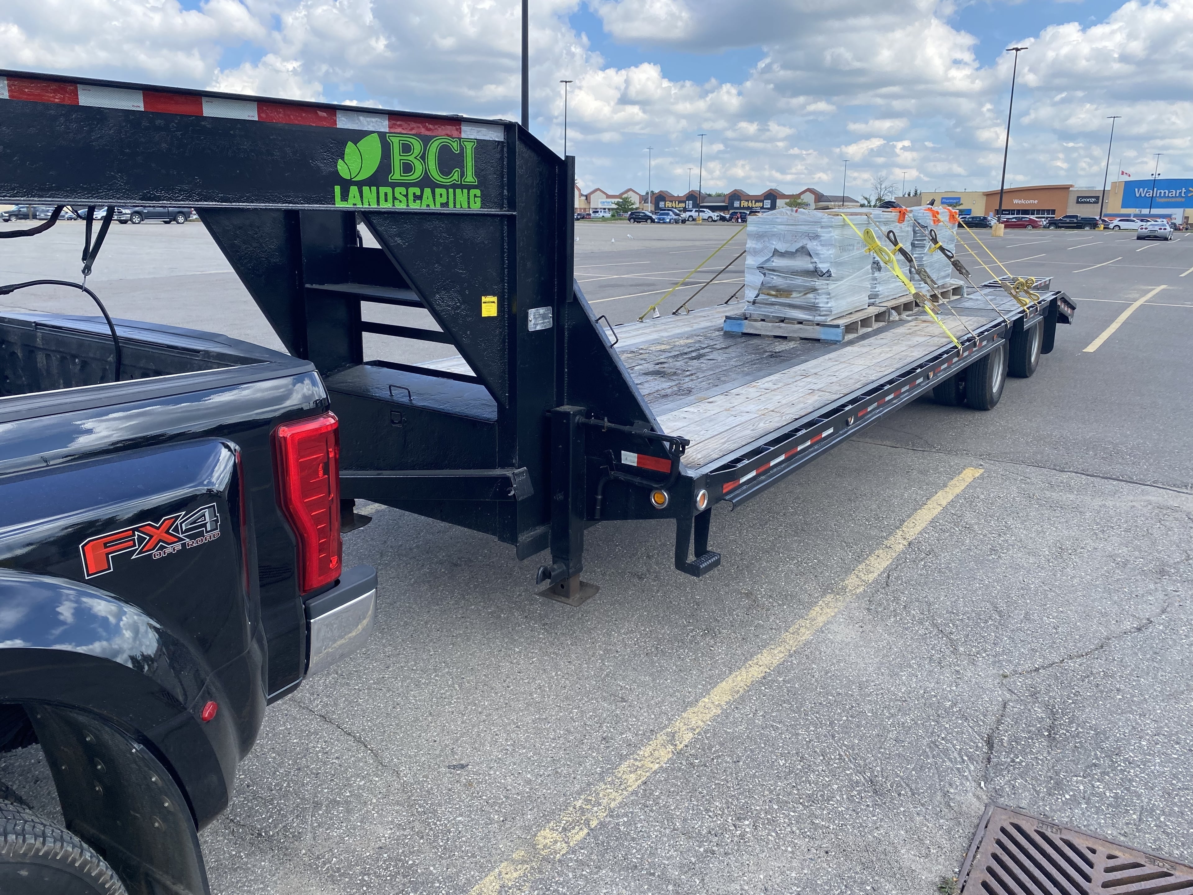 BCI Landscaping truck and branded trailer loaded with Techo-Bloc interlocking stone pavers for a Guelph landscaping project