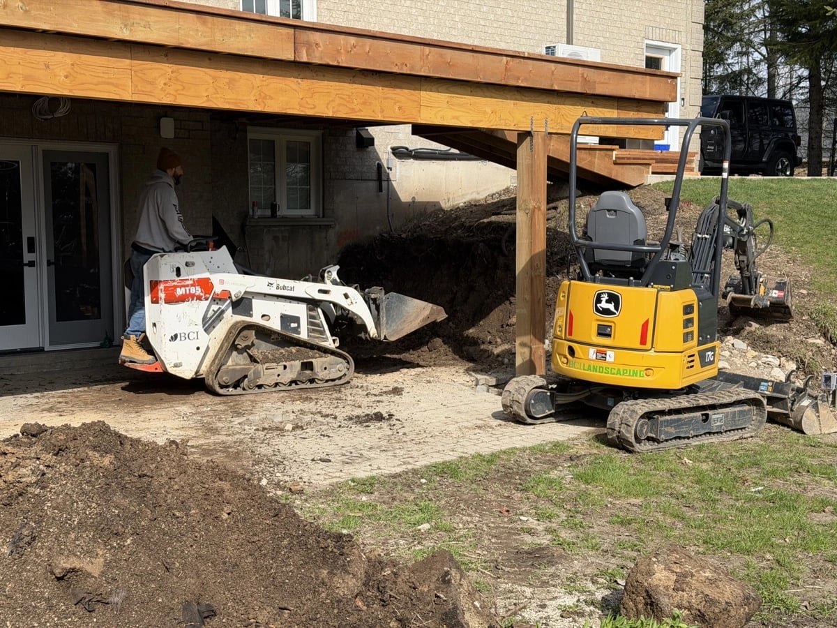 Excavation under a deck with Bobcat and mini-excavator on site, grading and excavation Guelph