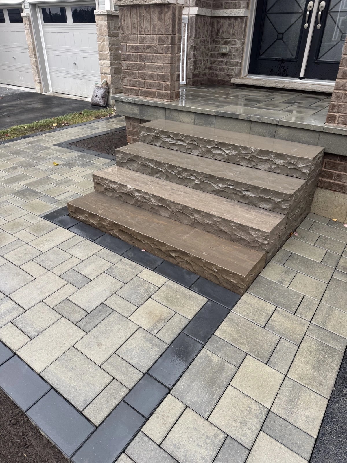 Natural stone front entrance steps with rough split face and interlock paver surround, stone steps Guelph by BCI Landscaping